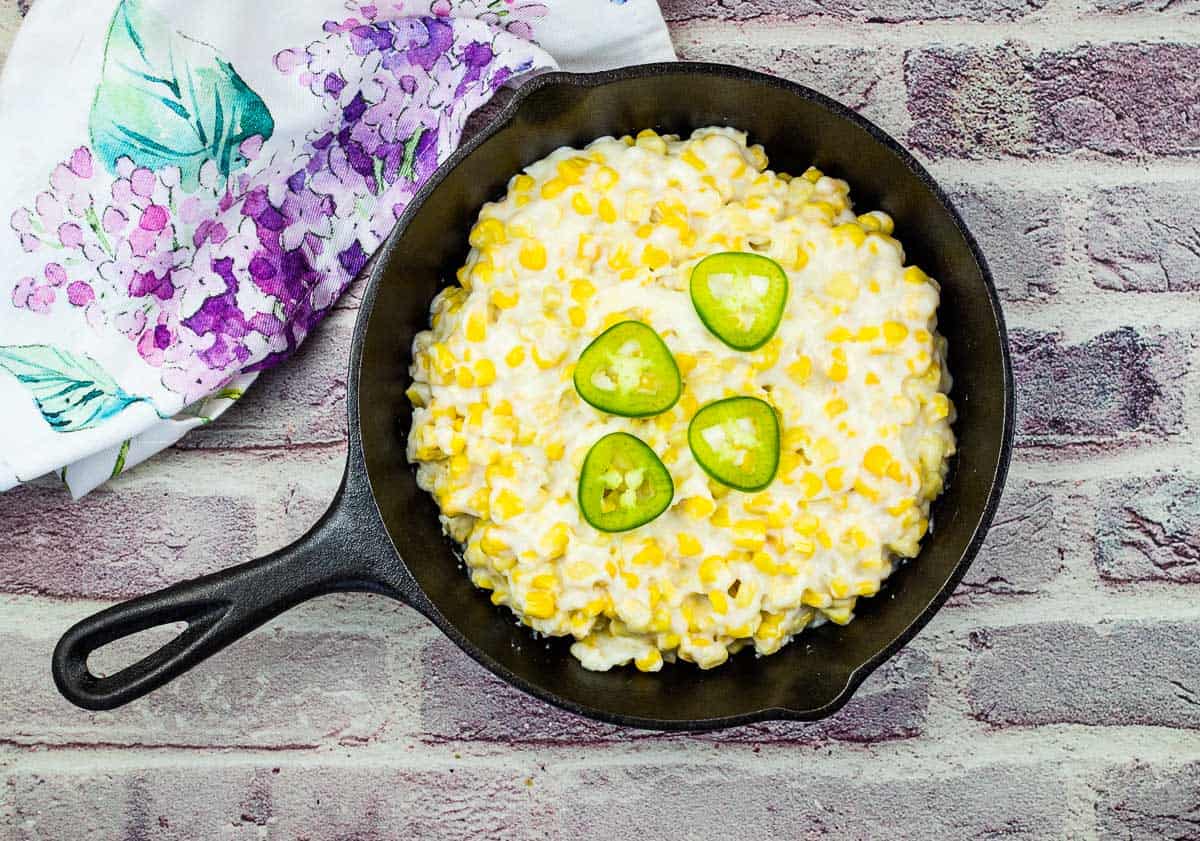 Smoked Creamed Corn in a black skillet.
