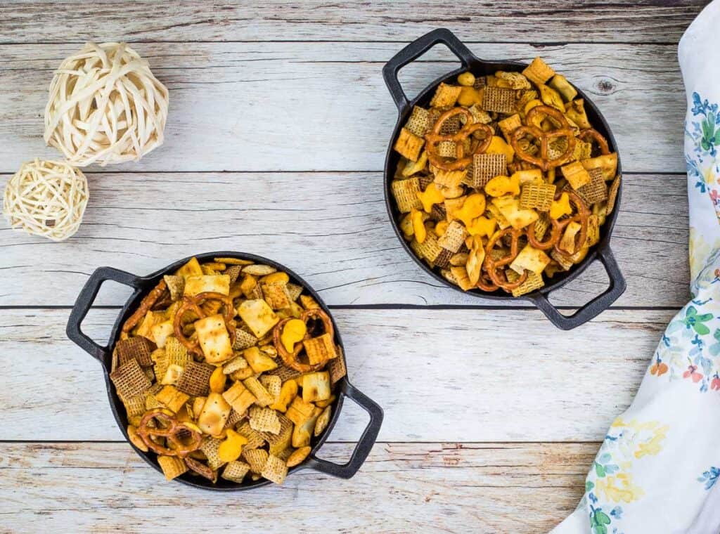 Smoked Chex Mix in two black bowls.