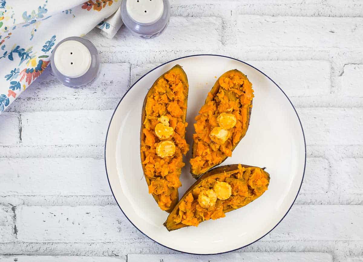 Smoked Sweet Potatoes with Chipotle Butter on a round white plate.