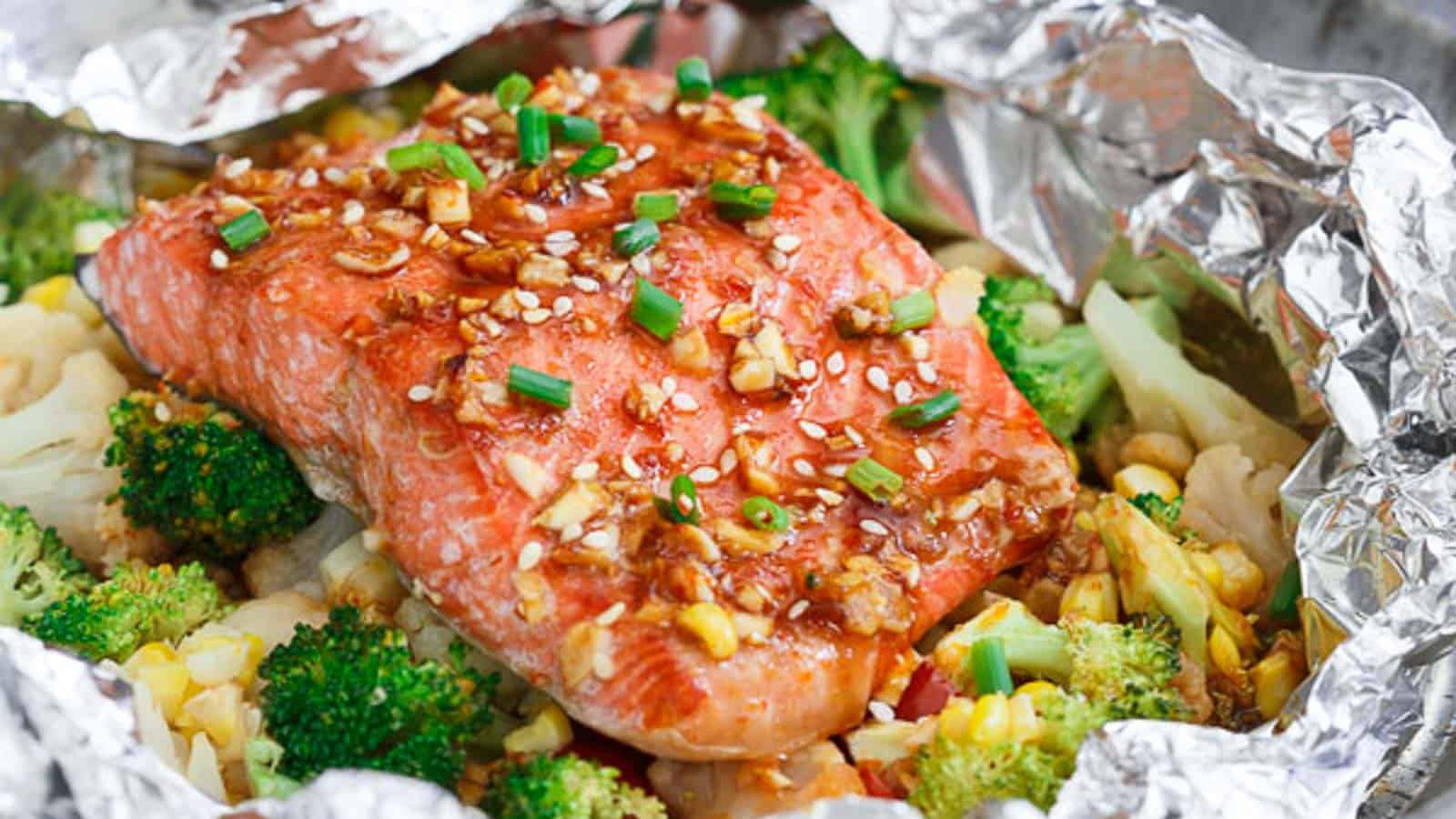 Sriracha honey salmon vegetable packets cooked in foil.
