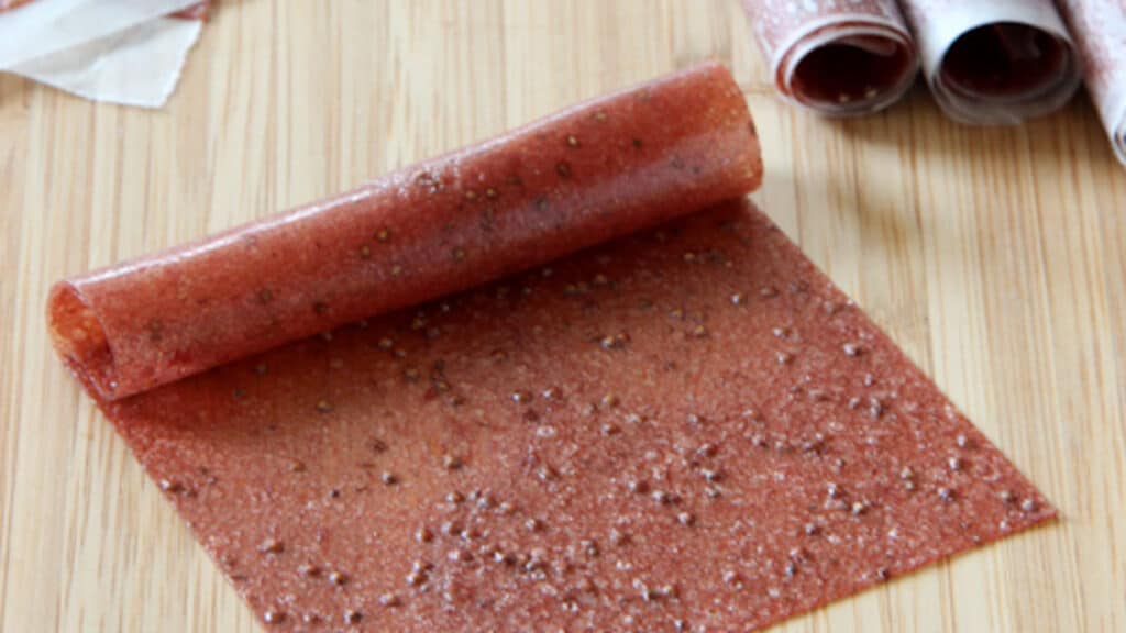Strawberry banana fruit leather on a cutting board.