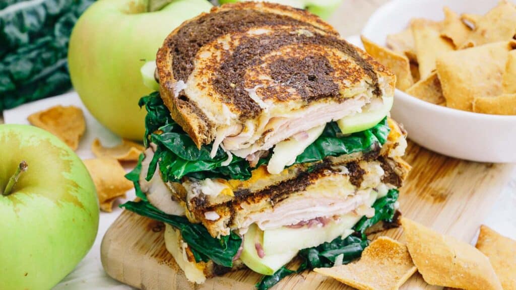 Sweet potato apple ham sandwich on marbled rye bread.