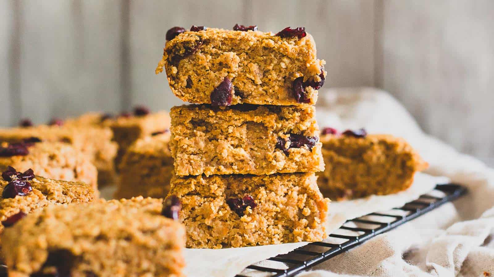 Sweet potato oat bars stacked on a kitchen towel.