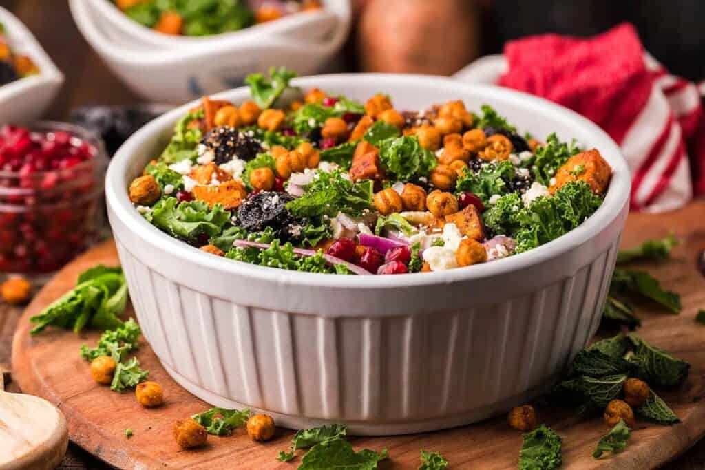 A sweet potato kale salad in a large white bowl. 