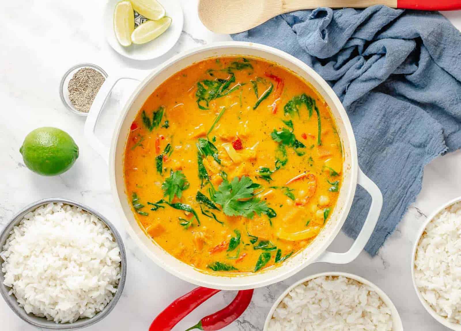 Overhead shot of a white pot with Thai pumplkin curry.