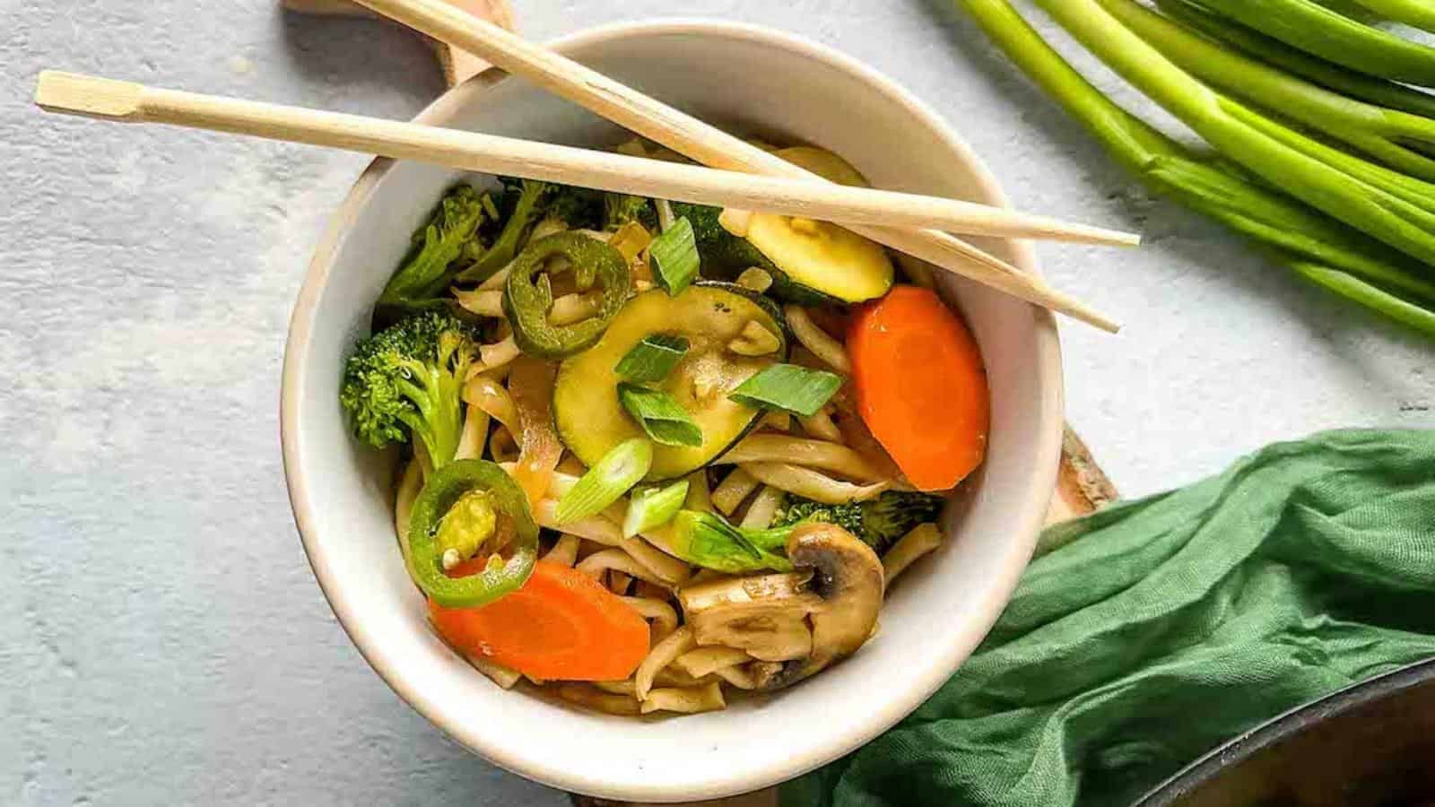 Vegetable yaki udon in a white bowl.