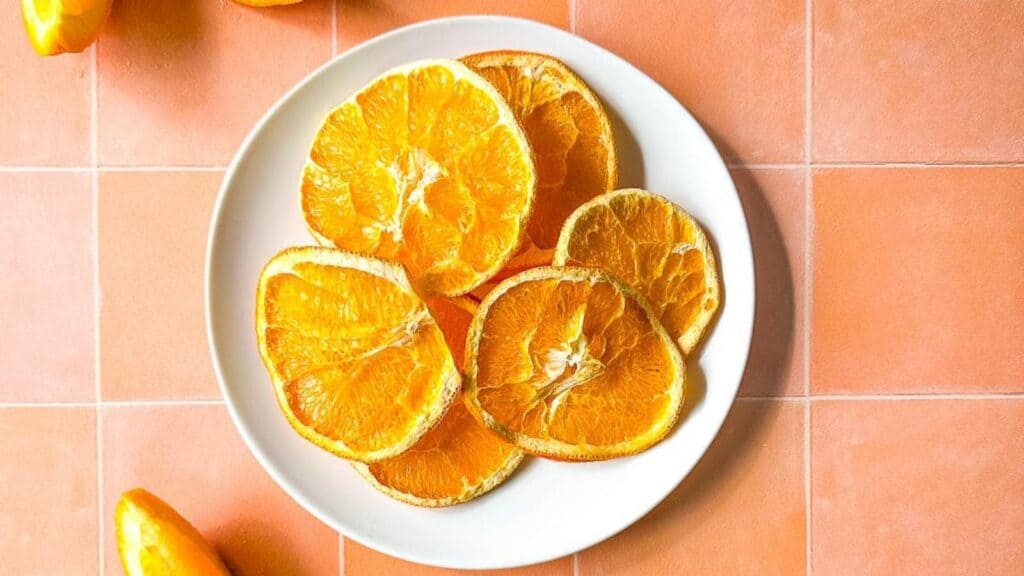 Air Fryer Dehydrated oranges on a white plate.