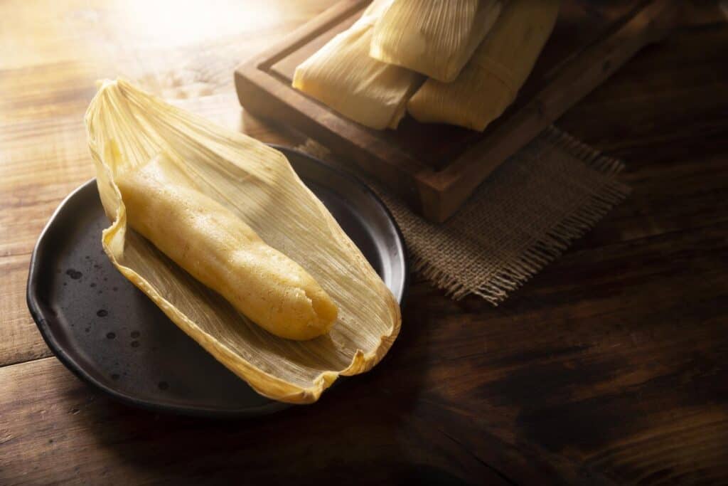 unwrapped tamale on black plate