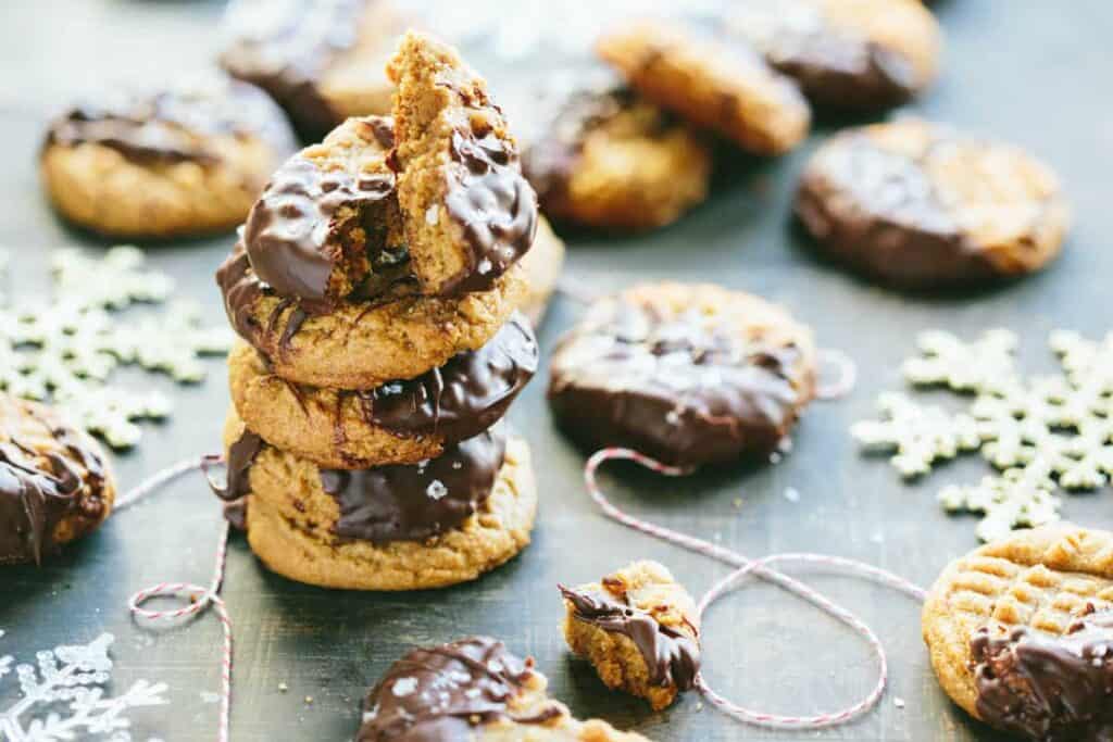 Stack of chocolate peanut butter cookies with chocolate along with snowflakes.
