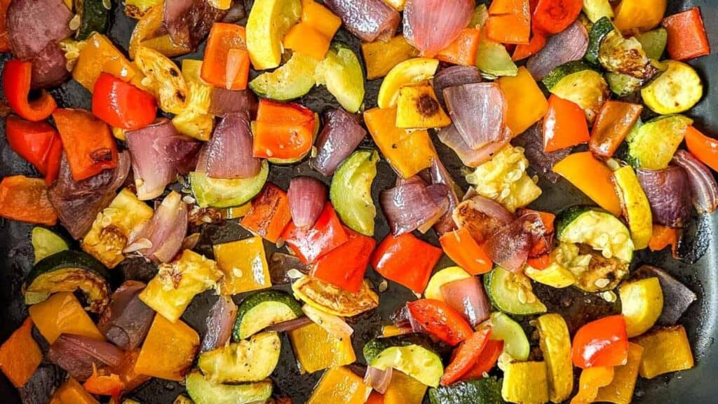 Roasted vegetables in a roasting pan.