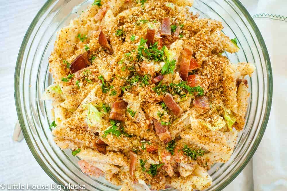 BLT pasta salad in a bowl topped with toast crumbs.