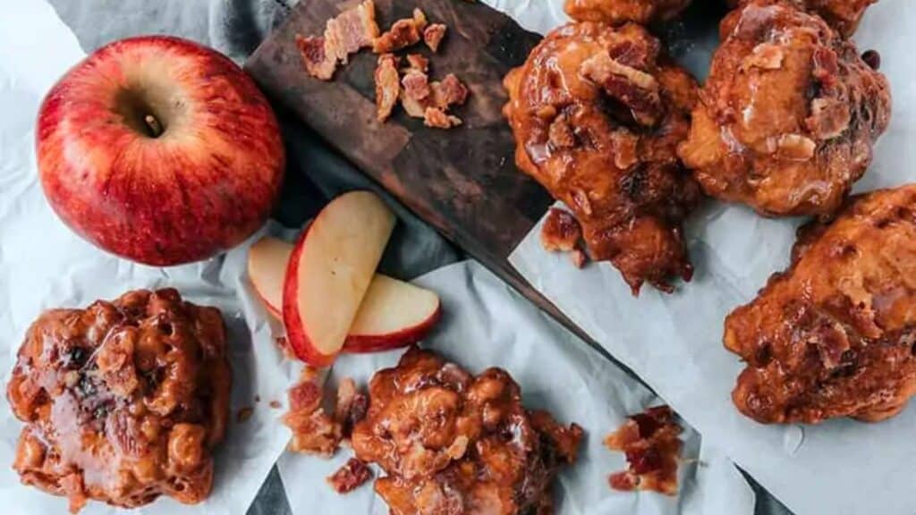 platter with bacon apple fritters and sliced apple.
