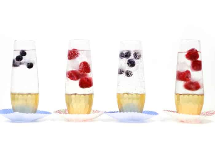 Four balsamic mocktails with berries in glasses.