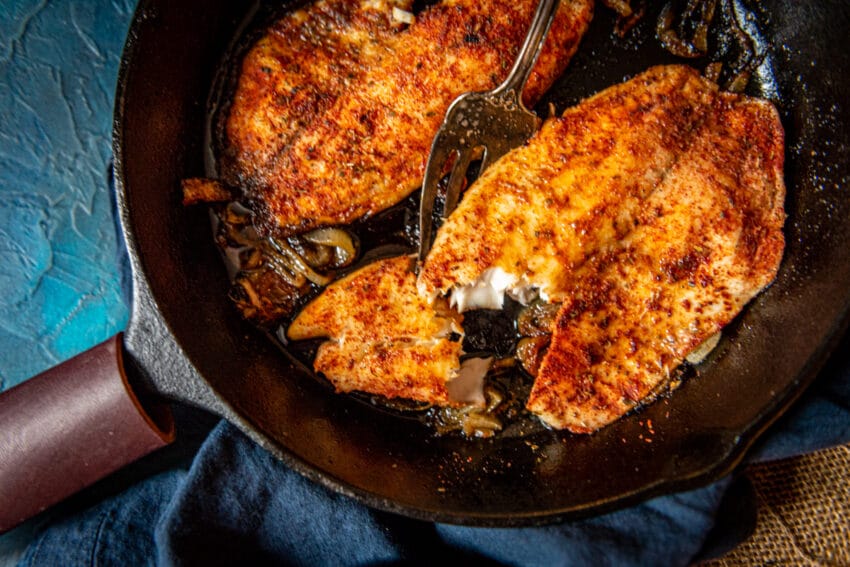 Beautiful grilled tilapia in a cast iron pan. 