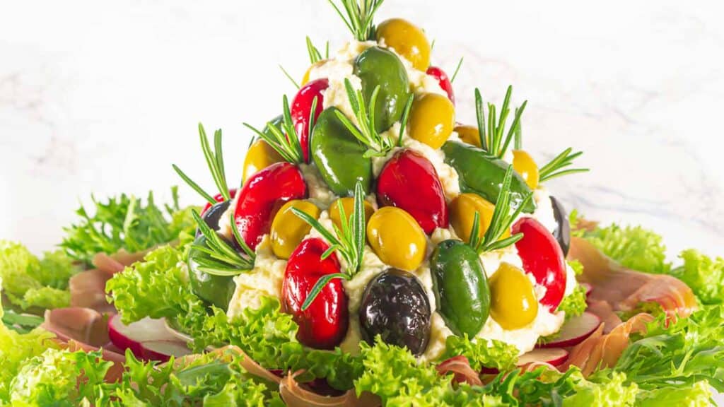 Antipasto Cheese Ball in a shape of a tree with olives.