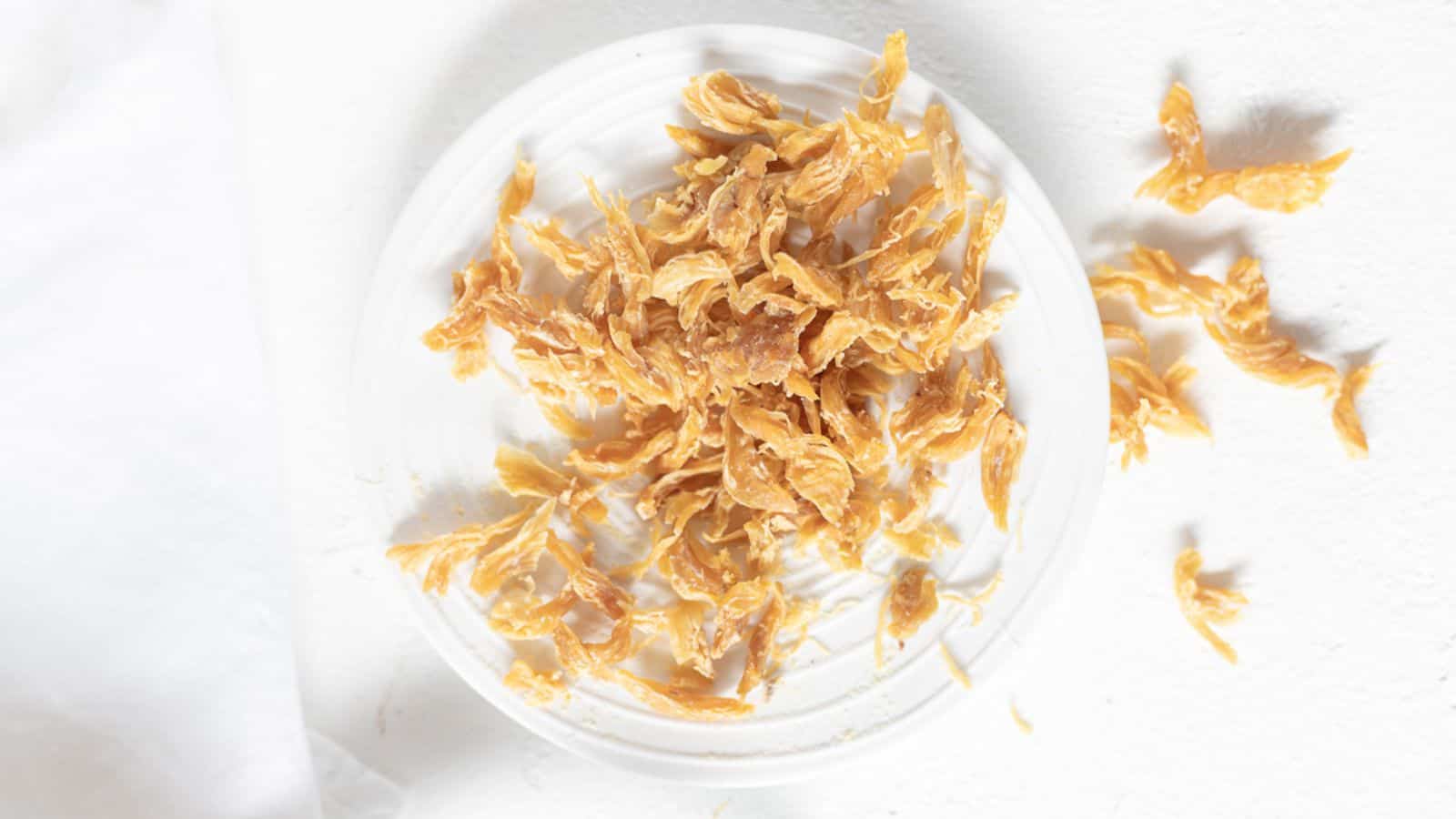 Dehydrated Chicken Jerky on a white plate. 