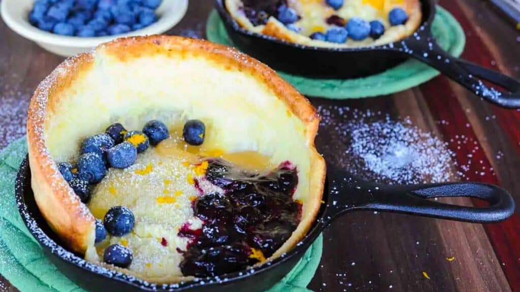 skillet with dutch baby pancakes and blueberry compote.