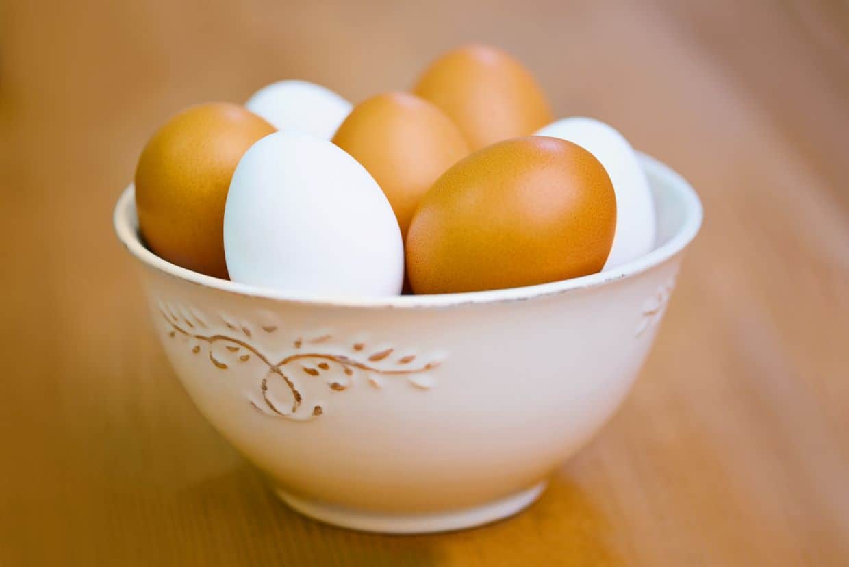 Brown and white eggs in a white bowl.