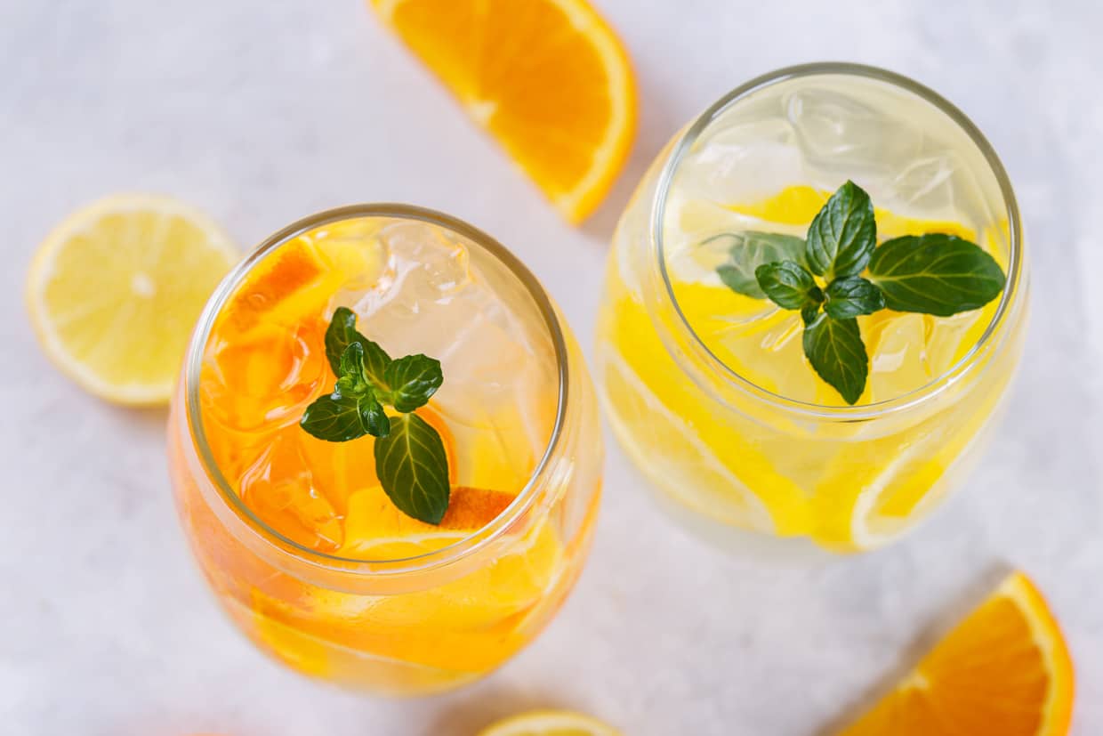 Citrus and herb drinks in glasses.