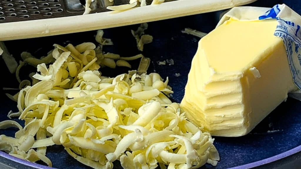 Grated butter in a blue bowl.