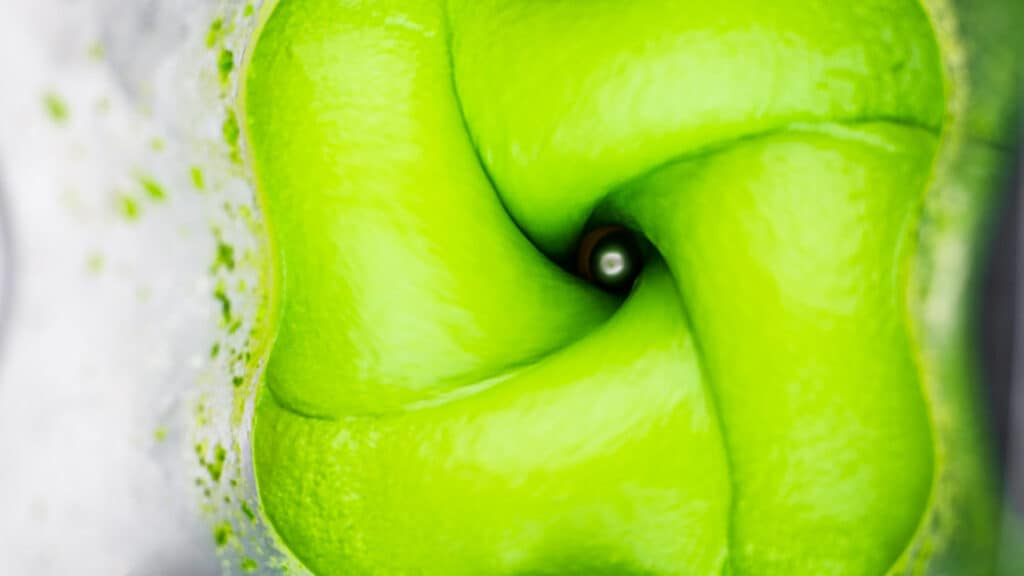 Green goddess vegan dressing blending in a blender.