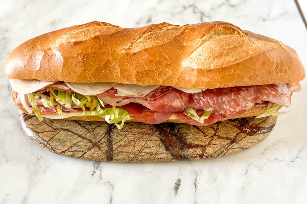 Grinder sandwich on a marble cutting board.
