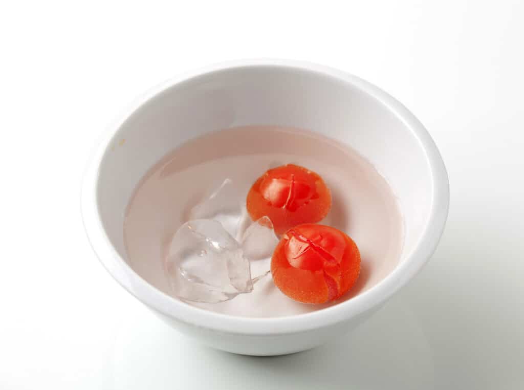 Tomatoes cooling in an ice bath. 