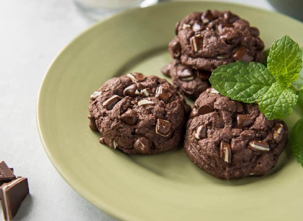 A green plate with chocolate mint cookies.