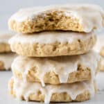 Four iced oatmeal cookies stacked.