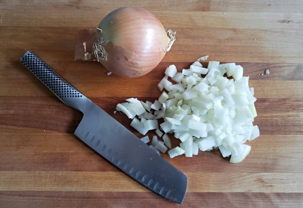 Overhead of chopped onion with knife.