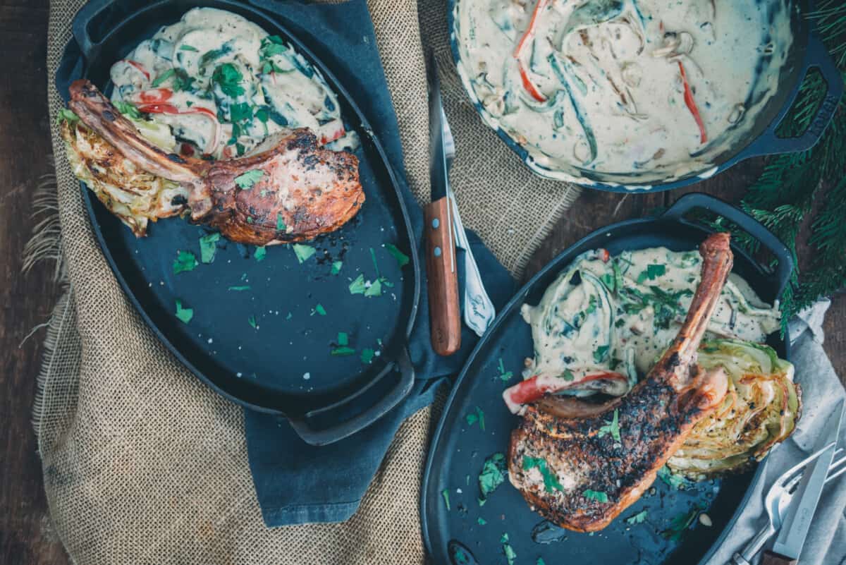 Overhead shot of plates with pork chops and rajas con crema