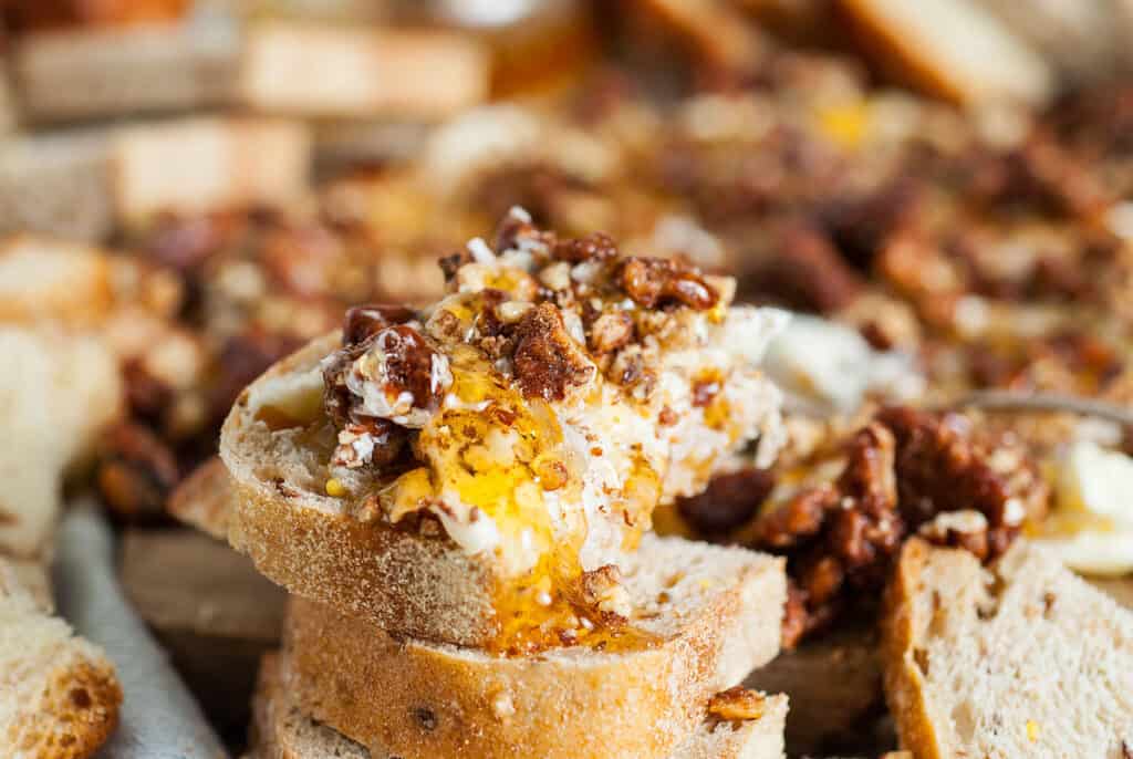 Slices of bread on a pecan honey butter board.