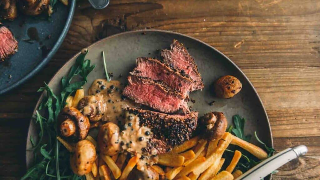 Steak with peppercorn sauce on top. 