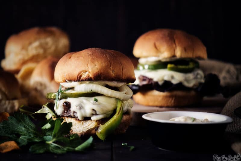 Dark and moody shot of philly burgers.