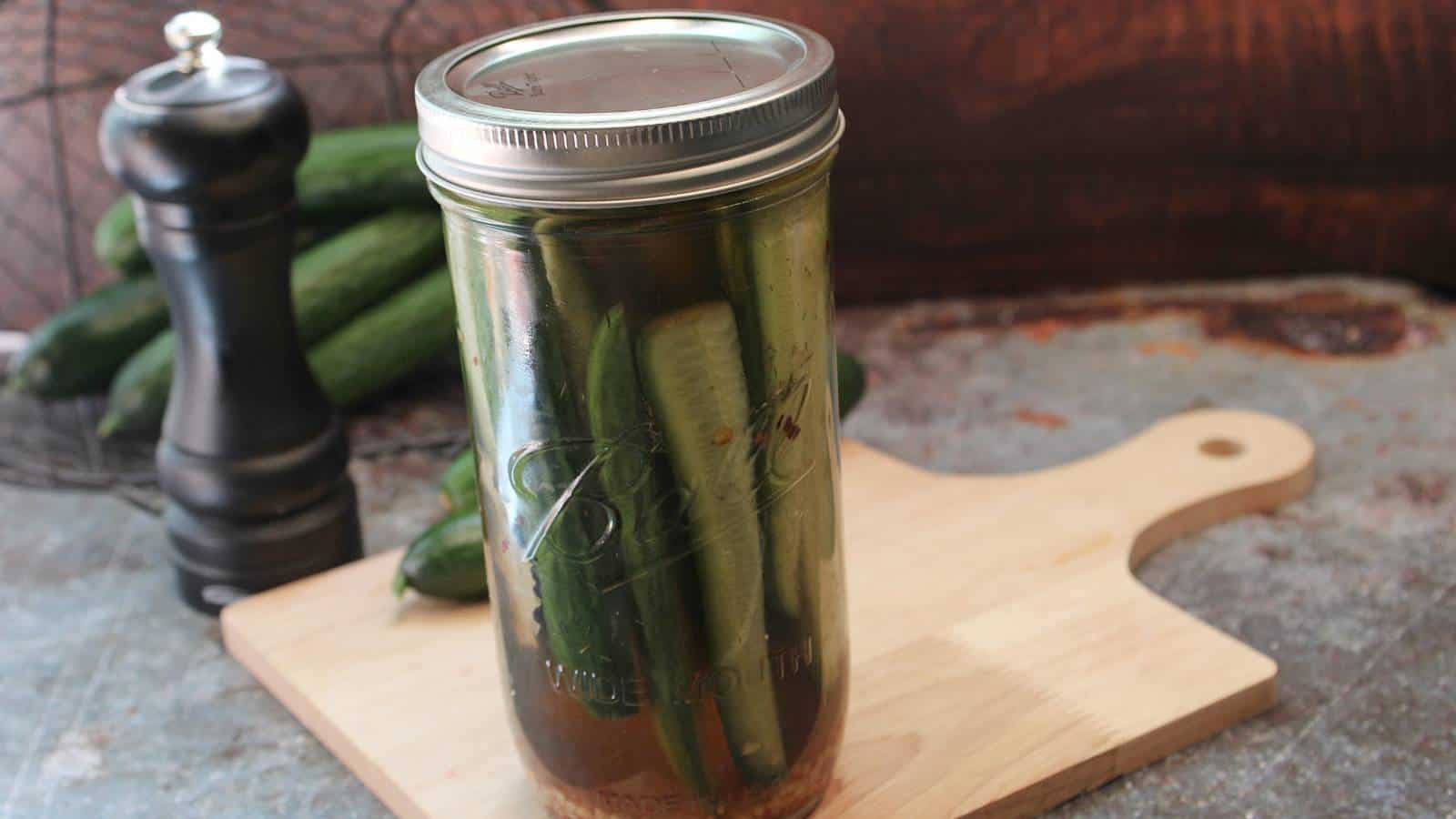 Homemade garlic dill pickles in a glass mason jar.