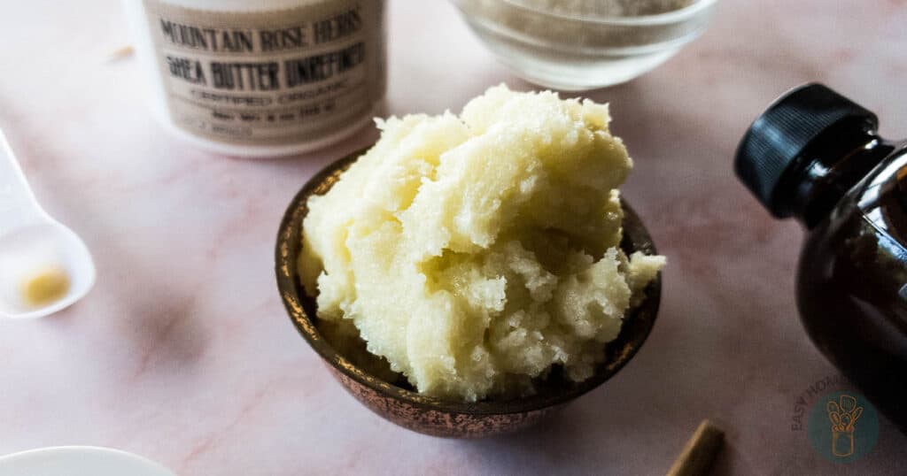 diy whipped body scrub in wooden bowl with shea butter and essential oil