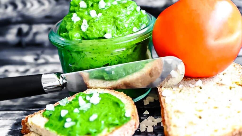 Wild garlic ramp pesto spread on a slice of bread. 