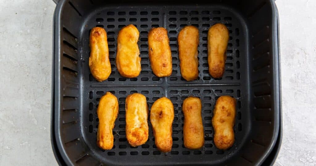 air fryer Tyson honey battered chicken tenders in an air fryer basket