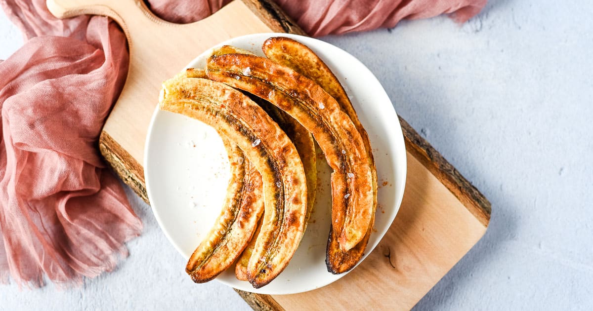 Air fried bananas on a white plate.