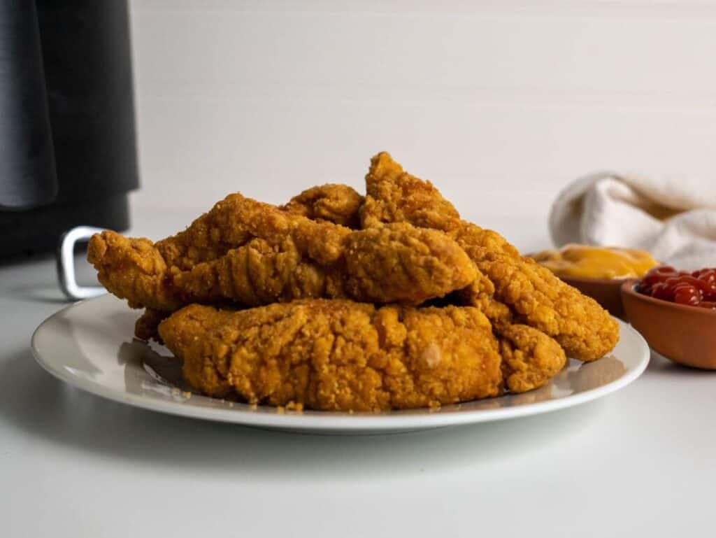 air fryer frozen chicken finger on a plate.