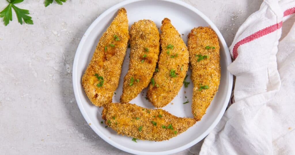 shake and bake chicken tenders on a white plate.