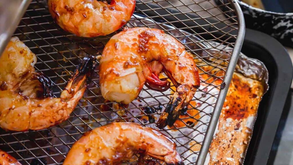 Garlic ginger shrimp on air fryer tray.