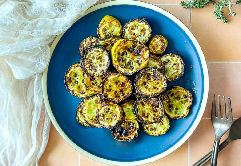 Air fryer zucchini and squash on a blue plate.