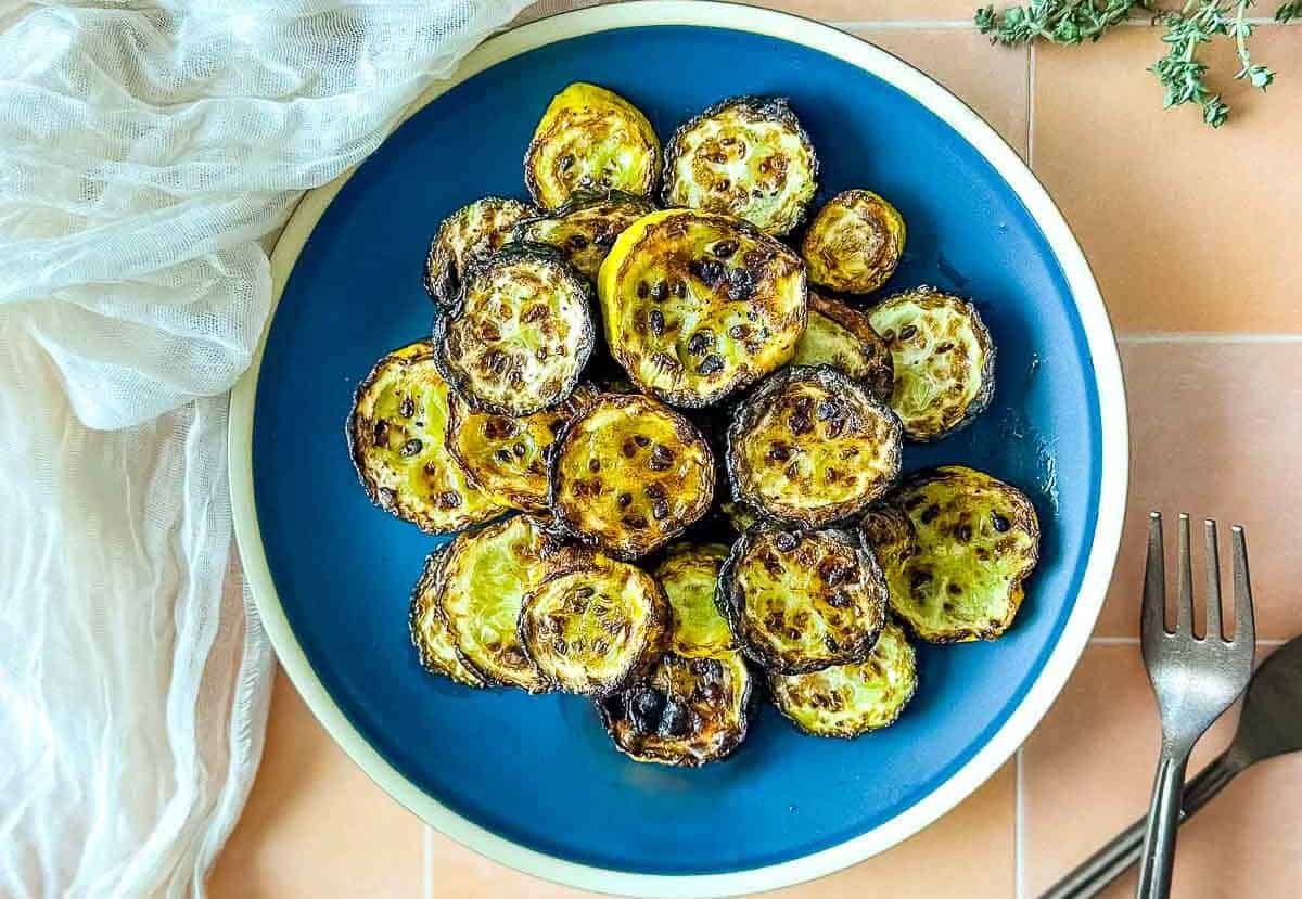 Air fryer zucchini and squash on a blue plate.