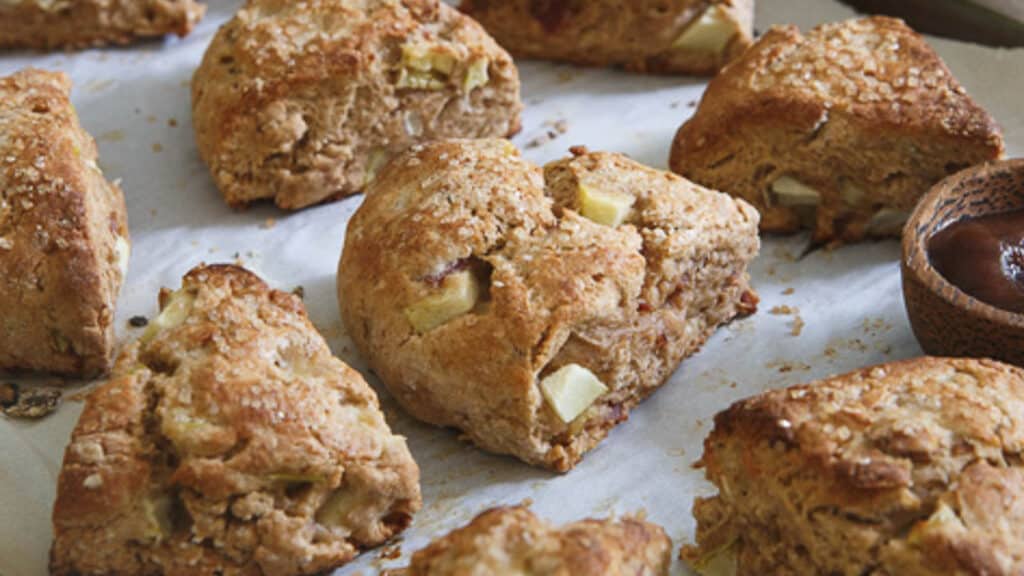 Apple bacon scones on parchment paper.