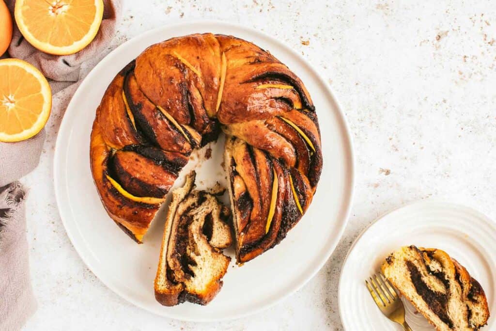 Overhead shot of chocolate orange babka. There is a section cut out so that you can see the inside.