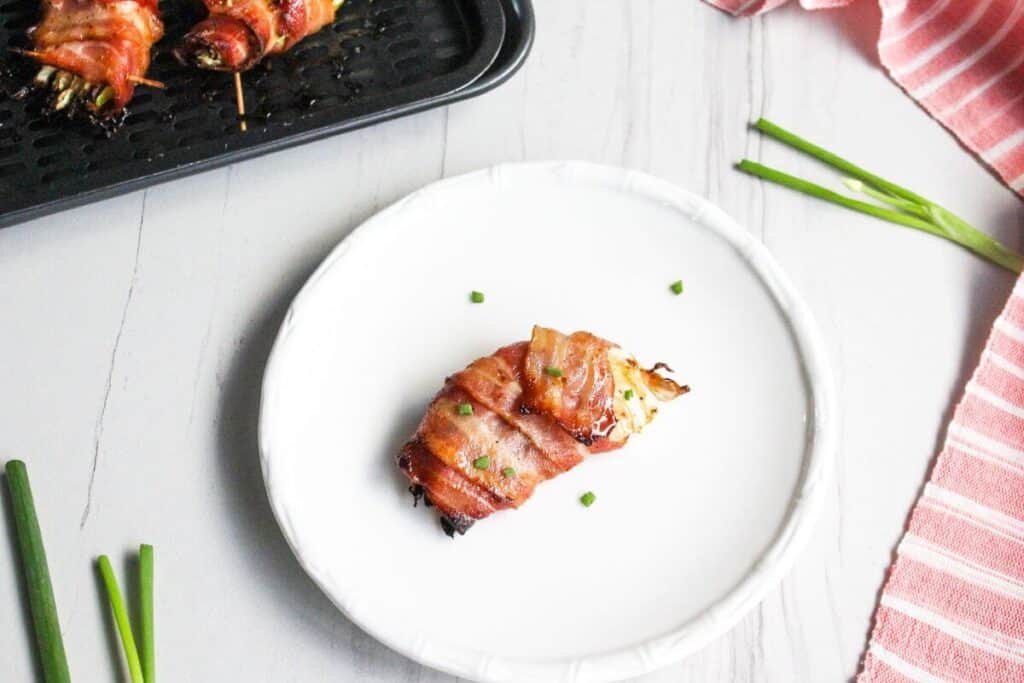 Bacon wrapped air fryer cabbage on white plate
