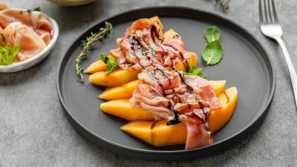 balsamic glaze on prosciutto and melon