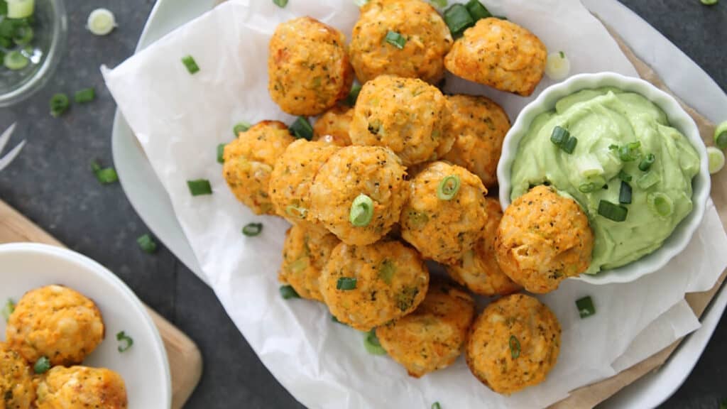 Buffalo chicken broccoli cheddar bites with avocado dipping sauce.