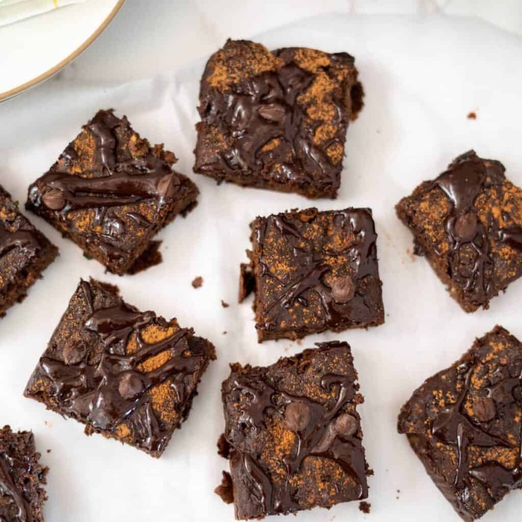 zucchini tahini brownie squares on a white background